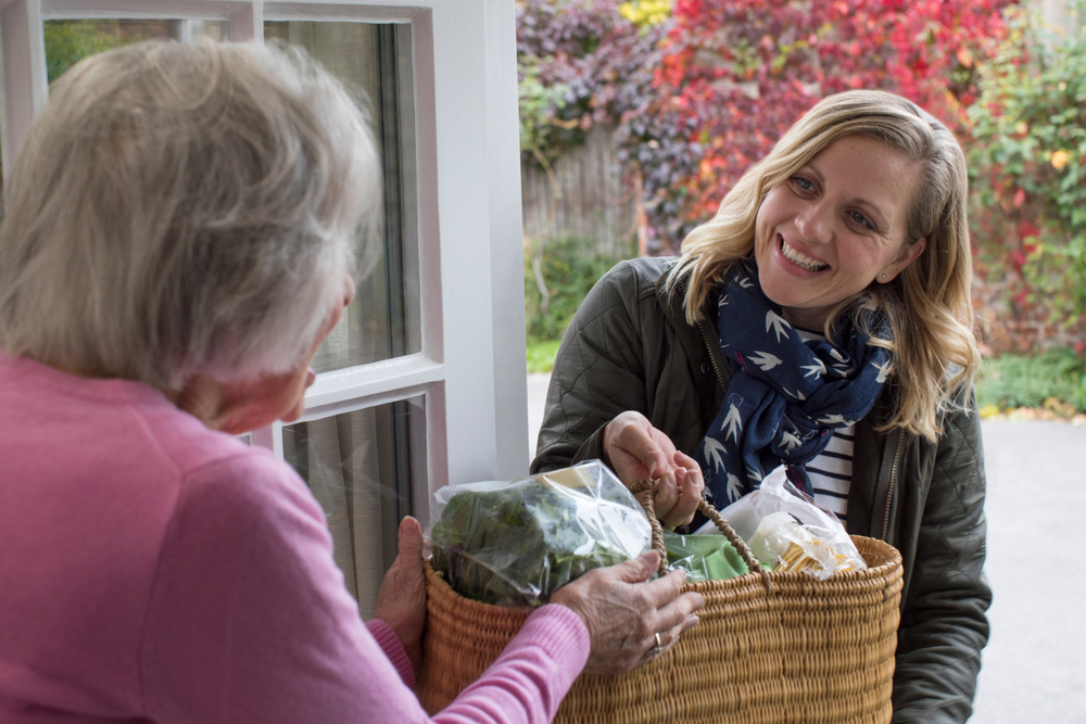 Female Helping Senior Neighbor